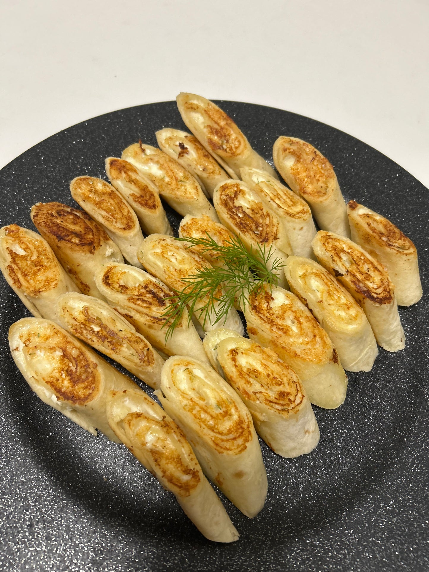 Baked mini tortillas with cheese, farmer cheese and garlic filling platter