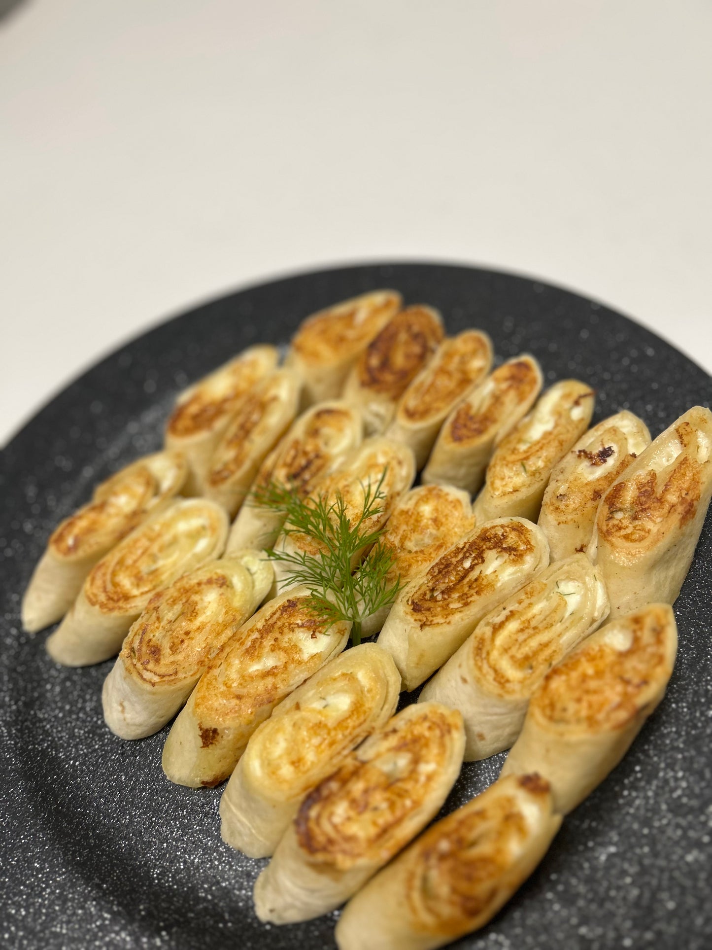 Baked mini tortillas with cheese, farmer cheese and garlic filling platter