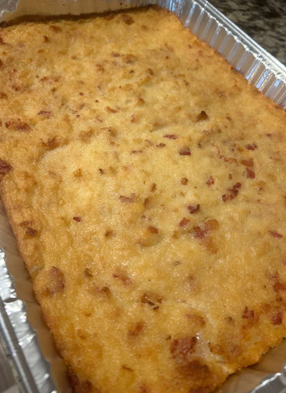 Homemade potato pie “Kugelis” with bacon filling